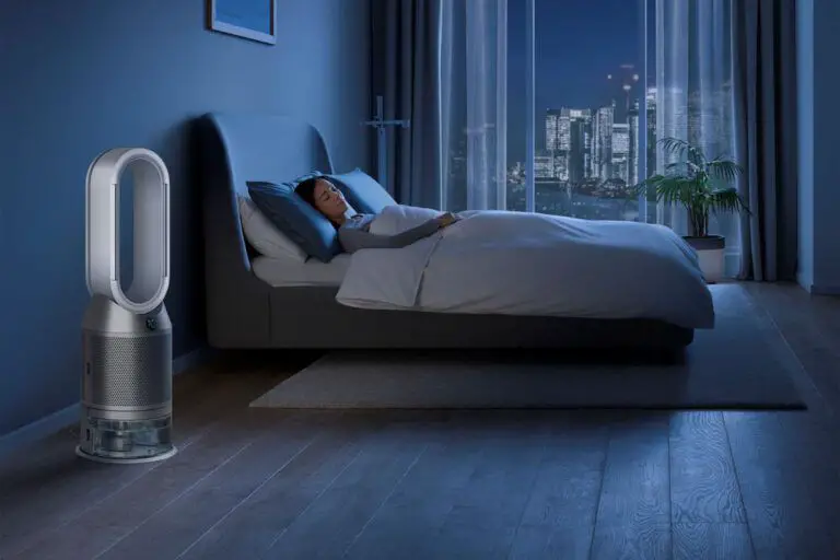 Woman sleeping in bedroom with air purifier at night.