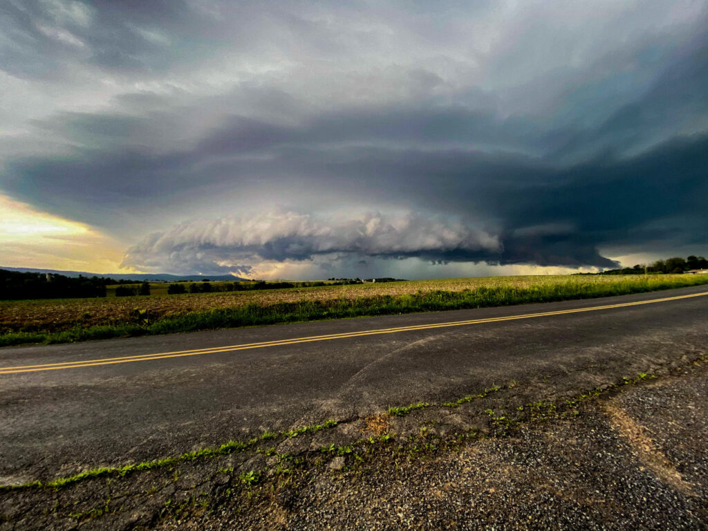 Dark stormy clouds over a rural road.