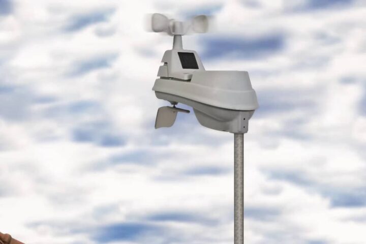 iris Weather sensor device against cloudy sky background.